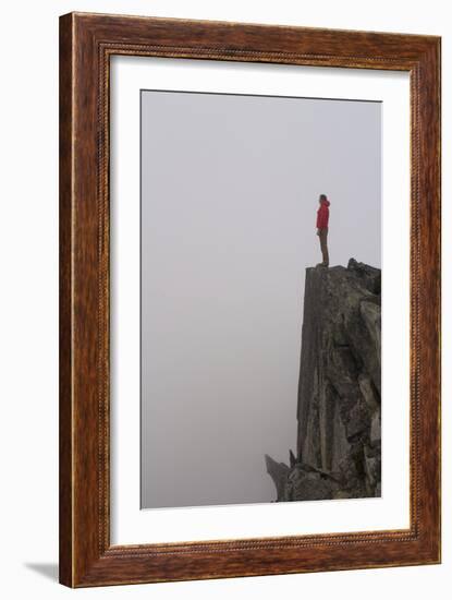 Woman Stands Looking Out Into The Fog On Top Of A Cliff In The North Cascades, Wa-Hannah Dewey-Framed Photographic Print