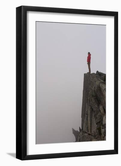 Woman Stands Looking Out Into The Fog On Top Of A Cliff In The North Cascades, Wa-Hannah Dewey-Framed Photographic Print