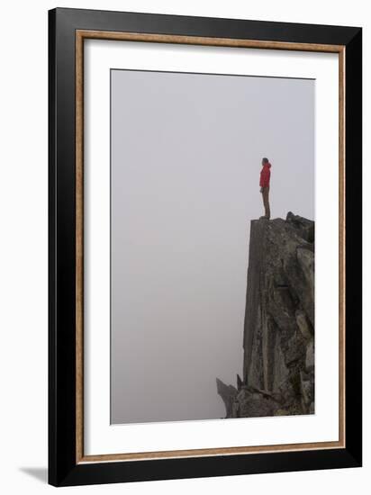 Woman Stands Looking Out Into The Fog On Top Of A Cliff In The North Cascades, Wa-Hannah Dewey-Framed Photographic Print