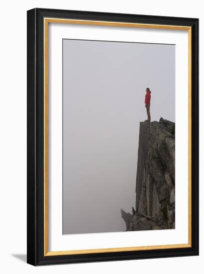 Woman Stands Looking Out Into The Fog On Top Of A Cliff In The North Cascades, Wa-Hannah Dewey-Framed Photographic Print