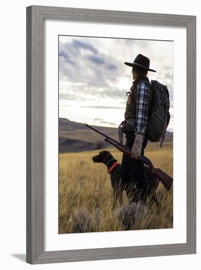 Woman Stands Next To Her Hunting Dog Looking Out Into Montana's Vast Landscape-Hannah Dewey-Framed Photographic Print