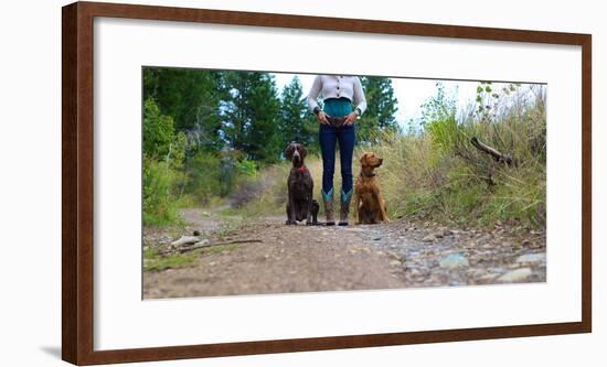 Woman Stands On A Forested Path With Her Two Dogs-Hannah Dewey-Framed Photographic Print