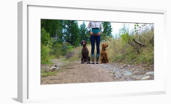 Woman Stands On A Forested Path With Her Two Dogs-Hannah Dewey-Framed Photographic Print