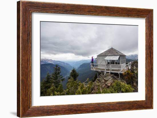 Woman Stands On The Edge Of A Backcountry Lookout Tower Overlooking The Cascade Mts Near Seattle-Michael Hanson-Framed Photographic Print