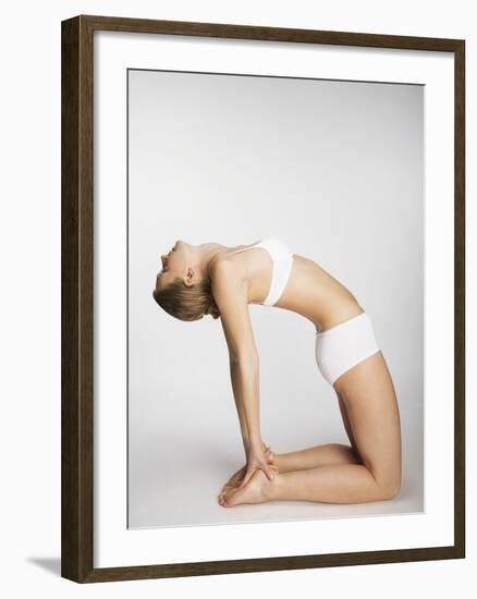 Woman stretching in camel pose-Mario Castello-Framed Photographic Print