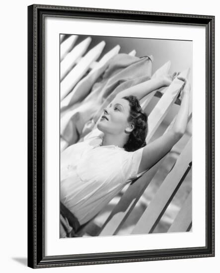 Woman Stretching Out on a Picket Fence-null-Framed Photo