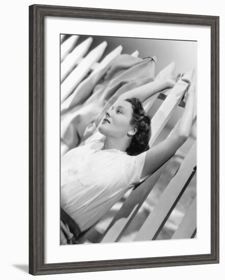 Woman Stretching Out on a Picket Fence-null-Framed Photo