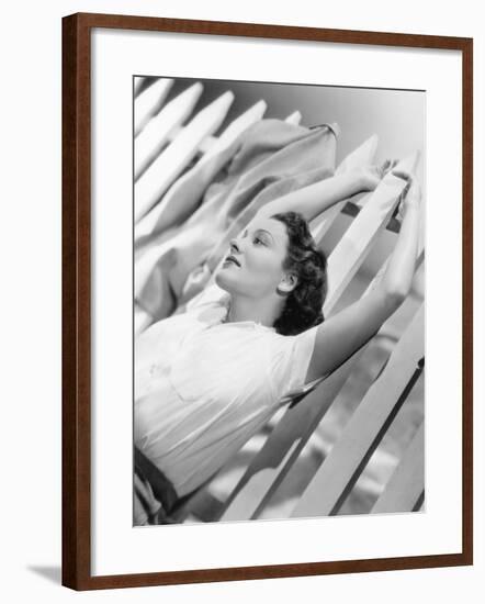 Woman Stretching Out on a Picket Fence-null-Framed Photo
