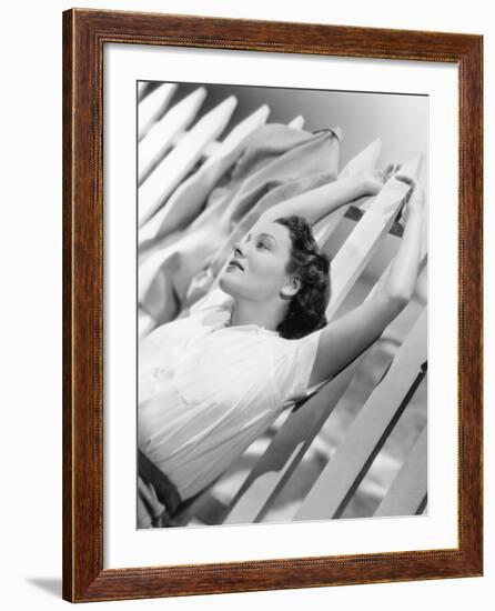 Woman Stretching Out on a Picket Fence-null-Framed Photo