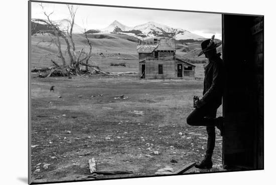Woman Takes A Drink Of Whiskey From Her Flask In An Old Abandoned Barn In Rural Montana-Hannah Dewey-Mounted Photographic Print