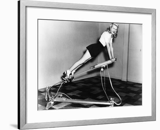 Woman Using Exercise Equipment-null-Framed Photo