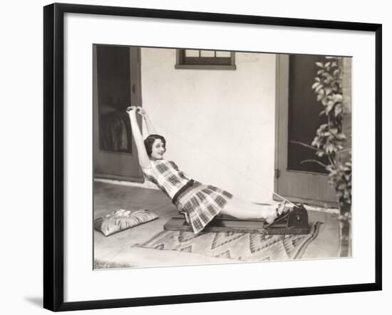 Woman Using Rowing Machine at Home-null-Framed Photo