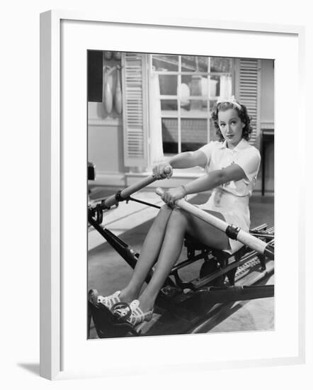 Woman Using Rowing Machine-null-Framed Photo