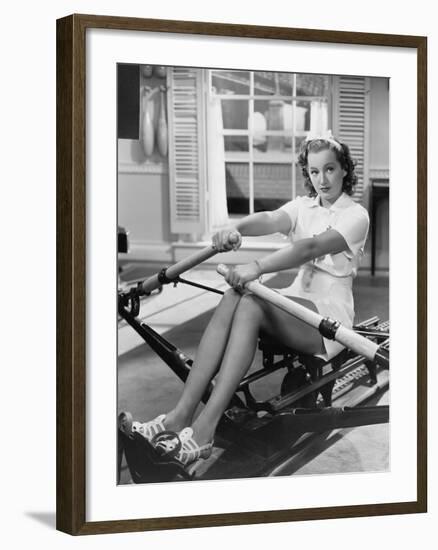 Woman Using Rowing Machine-null-Framed Photo