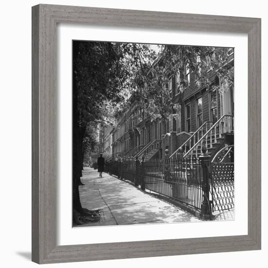 Woman Walking Down Street in Front of Apartment Buildings-Ed Clark-Framed Photographic Print
