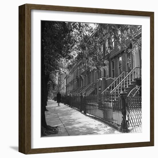 Woman Walking Down Street in Front of Apartment Buildings-Ed Clark-Framed Photographic Print