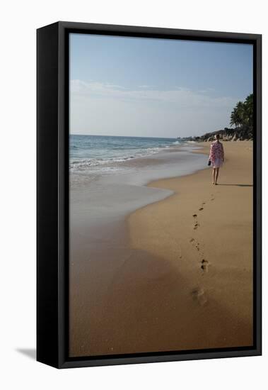 Woman Walking Leaving Footprints on Deserted Beach, Niraamaya, Kovalam, Kerala, India, Asia-James Strachan-Framed Premier Image Canvas