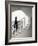 Woman walking up staircase holding handrail-John Edward Linden-Framed Photo