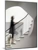 Woman walking up staircase holding handrail-John Edward Linden-Mounted Photo