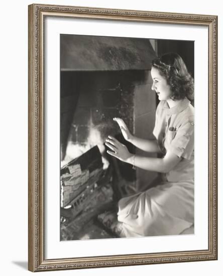 Woman Warming Her Hands by the Fireplace-null-Framed Photo