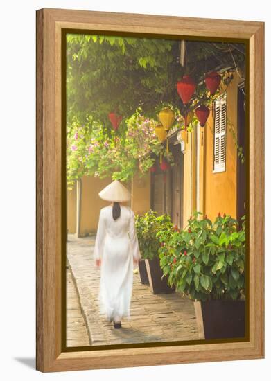 Woman Wearing Ao Dai Dress Walking Along Street, Hoi An, Quang Ham, Vietnam-Ian Trower-Framed Premier Image Canvas