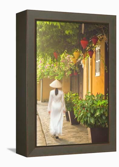 Woman Wearing Ao Dai Dress Walking Along Street, Hoi An, Quang Ham, Vietnam-Ian Trower-Framed Premier Image Canvas