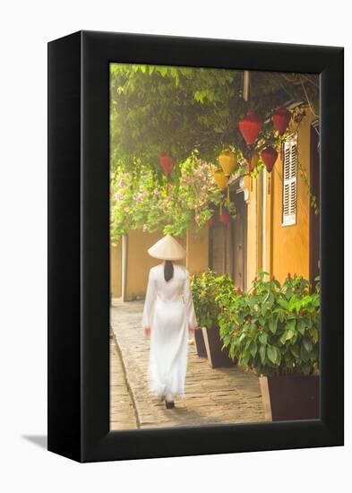 Woman Wearing Ao Dai Dress Walking Along Street, Hoi An, Quang Ham, Vietnam-Ian Trower-Framed Premier Image Canvas