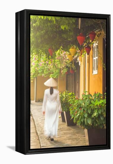 Woman Wearing Ao Dai Dress Walking Along Street, Hoi An, Quang Ham, Vietnam-Ian Trower-Framed Premier Image Canvas