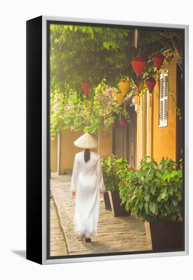 Woman Wearing Ao Dai Dress Walking Along Street, Hoi An, Quang Ham, Vietnam-Ian Trower-Framed Premier Image Canvas