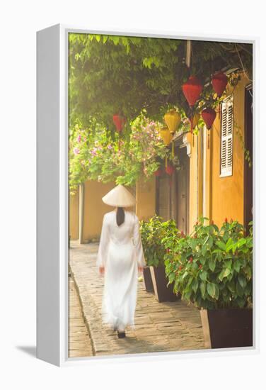 Woman Wearing Ao Dai Dress Walking Along Street, Hoi An, Quang Ham, Vietnam-Ian Trower-Framed Premier Image Canvas