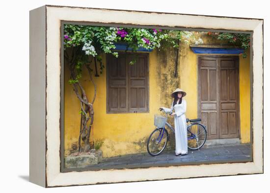 Woman Wearing Ao Dai Dress with Bicycle, Hoi An, Quang Ham, Vietnam-Ian Trower-Framed Premier Image Canvas