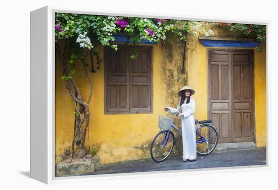 Woman Wearing Ao Dai Dress with Bicycle, Hoi An, Quang Ham, Vietnam-Ian Trower-Framed Premier Image Canvas