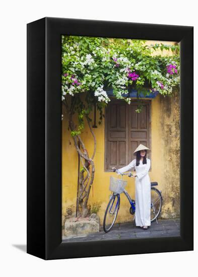 Woman Wearing Ao Dai Dress with Bicycle, Hoi An, Quang Ham, Vietnam-Ian Trower-Framed Premier Image Canvas