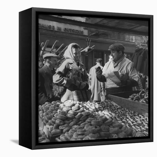 Woman with a Small Terrier Buying Bagels at a Market Stall, Possibly London, C.1945-50-null-Framed Premier Image Canvas