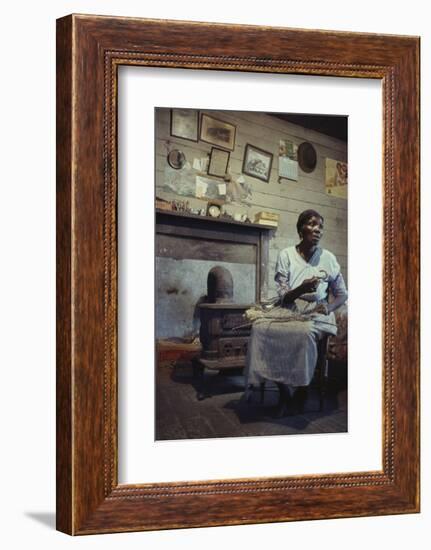 Woman with Cotton Stalks Beside a Wood-Burning Stove, Edisto Island, South Carolina, 1956-Walter Sanders-Framed Photographic Print