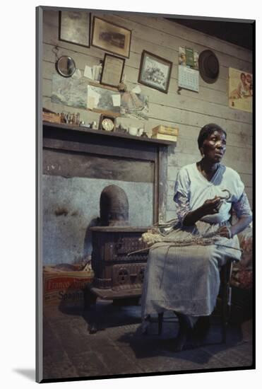 Woman with Cotton Stalks Beside a Wood-Burning Stove, Edisto Island, South Carolina, 1956-Walter Sanders-Mounted Photographic Print