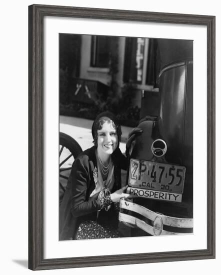 Woman with Prosperity Sign on Car Bumper-null-Framed Photo