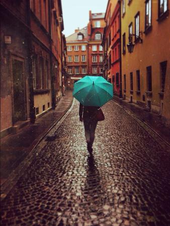 Woman With Umbrella Walking On The Rain In Old Town Of Warsaw