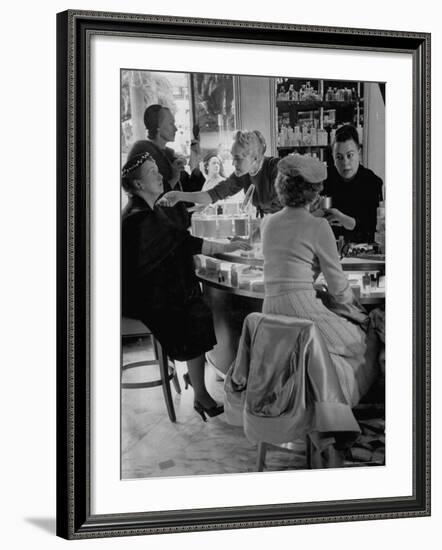 Women at a Powder Bar in Department Store Being Advised on Make Up by Operators-Leonard Mccombe-Framed Photographic Print