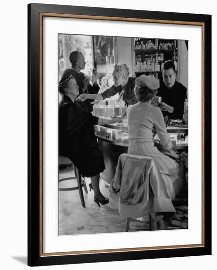 Women at a Powder Bar in Department Store Being Advised on Make Up by Operators-Leonard Mccombe-Framed Photographic Print