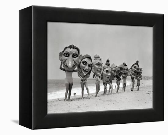 Women Holding Giant Masks-Bettmann-Framed Premier Image Canvas