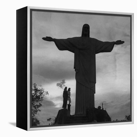 Women Posing with the Statue Called "Christ the Redeemer"-Hart Preston-Framed Premier Image Canvas