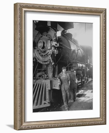 Women Rail Workers Standing at Work on Engine of Train, During WWI at Great Northern Railway-null-Framed Photographic Print