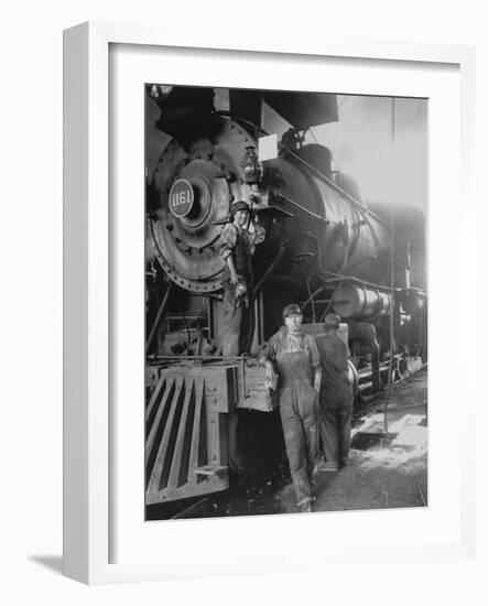 Women Rail Workers Standing at Work on Engine of Train, During WWI at Great Northern Railway-null-Framed Photographic Print