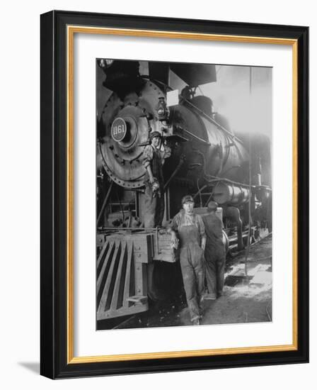 Women Rail Workers Standing at Work on Engine of Train, During WWI at Great Northern Railway-null-Framed Photographic Print