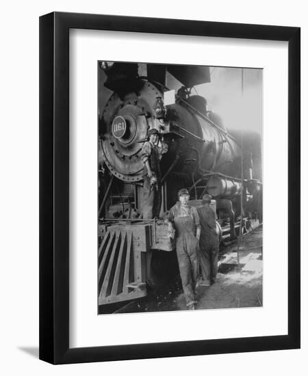 Women Rail Workers Standing at Work on Engine of Train, During WWI at Great Northern Railway-null-Framed Photographic Print