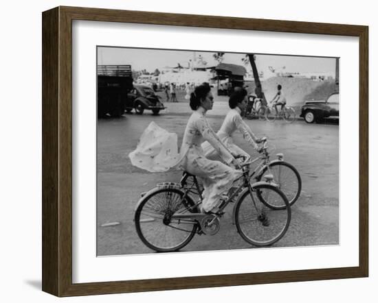 Women Riding Bicycles in Saigon-John Dominis-Framed Photographic Print