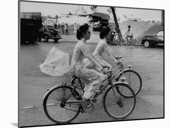 Women Riding Bicycles in Saigon-John Dominis-Mounted Photographic Print