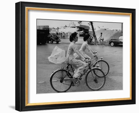 Women Riding Bicycles in Saigon-John Dominis-Framed Photographic Print