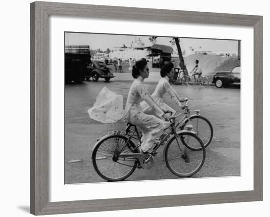 Women Riding Bicycles in Saigon-John Dominis-Framed Photographic Print